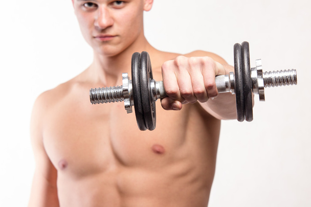 Muscular fitness man holding dumbbell - Zdjęcie, obraz