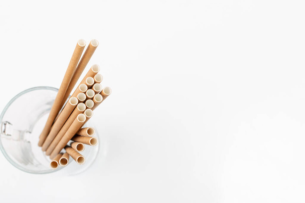 Paper drink straw isolated. Brown disposable drinking straws, eco-friendly cocktail tubes, zero waste pipe on white background - Fotó, kép