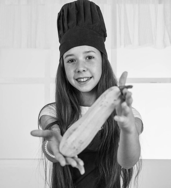 girl kid in chef apron and hat cooking, squash. - Zdjęcie, obraz