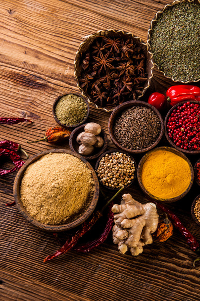 Oriental hot spices on wooden table - Fotó, kép