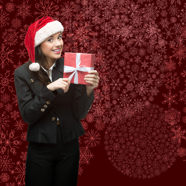 business woman in santa hat holding gift - 写真・画像