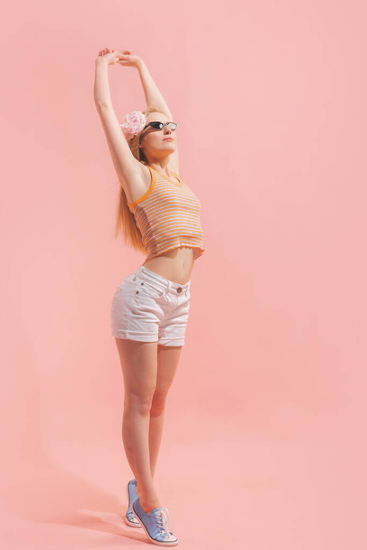 Beauty. Studio shot of young pretty girl in summer fashion collection outfit posing isolated on pink background. Concept of emotions, facial expression, youth, aspiration, sales - Foto, Imagem