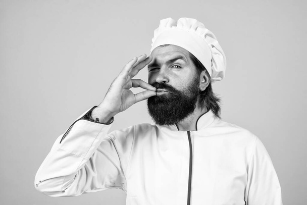 confident chef hipster with beard and moustache in cook uniform show sigh of excellence, excellent. - Фото, изображение