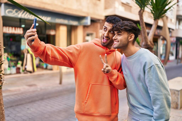 Two man couple making selfie by smartphone at street - 写真・画像