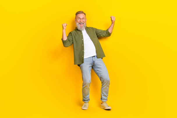 Full size portrait of delighted person raise fists celebrate success scream yeah hooray isolated on yellow color background. - Foto, immagini