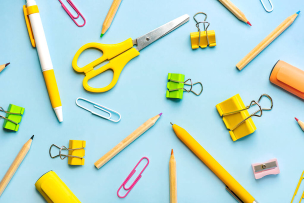 Top view of school supplies on blue background. Back to school concept - Photo, Image
