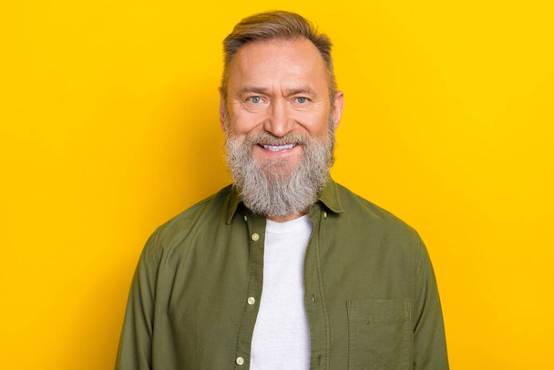 Portrait of satisfied glad aged person toothy beaming smile look camera isolated on yellow color background. - Photo, image