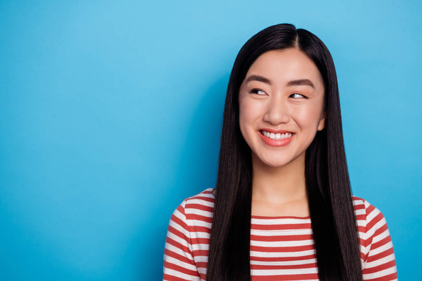 Portrait of charming minded malaysian girl toothy smile look interested empty space isolated on blue color background. - Fotografie, Obrázek
