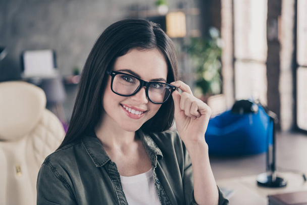 Photo of young cheerful lovely woman hand touch eyeglasses support website testing designer leader indoors. - Foto, immagini