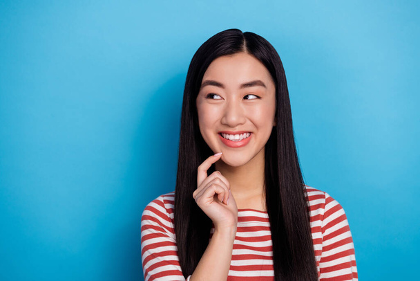 Portrait of cheerful positive filipino girl finger touch chin look empty space hmm deep isolated on blue color background. - Fotografie, Obrázek