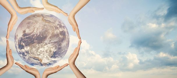 Earth globe in human hands against sky background - Foto, Imagen