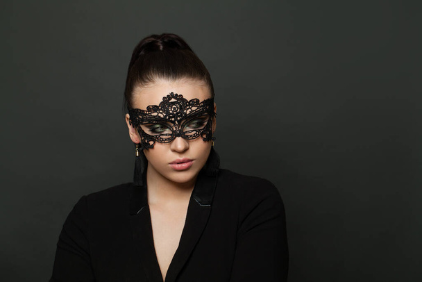 Pretty sensual beautiful young woman with lace mask, studio shot - Valokuva, kuva