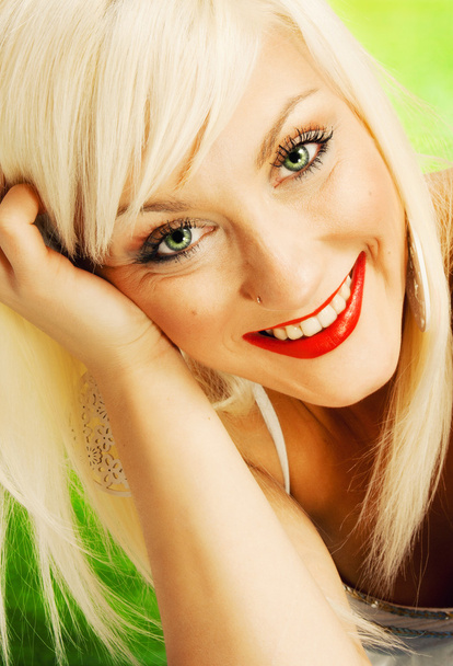 Beautiful blond woman on green background - Fotó, kép