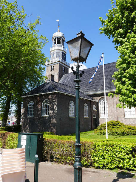 Lanterna velha e kerk hervormde (igreja reformada) em (holandês) Lemmer (frísio) De Lemmer (cidade portuária no Ijsselmeer, um lago muito grande), Frísia (texto à esquerda: "fora de ordem") - Foto, Imagem