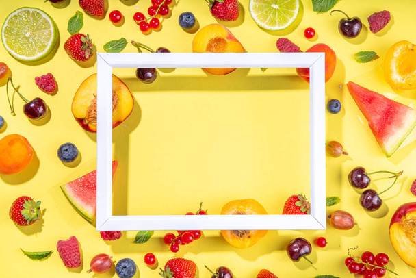 Summer vitamin food concept, various fruit and berries watermelon peach mint plum apricots blueberry strawberry currant, creative flat lay on yellow background top view copy space - Foto, imagen
