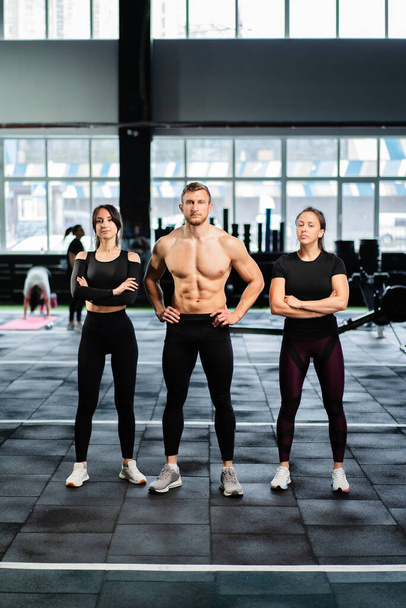 sexy caucasian man and women in gym train in fitness club with weights lifestyle wellness exercising with joy - Photo, Image