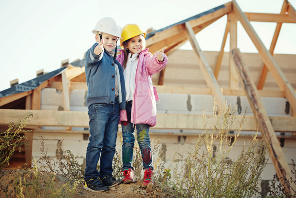 boy and girl playing on construction site - Foto, Imagen