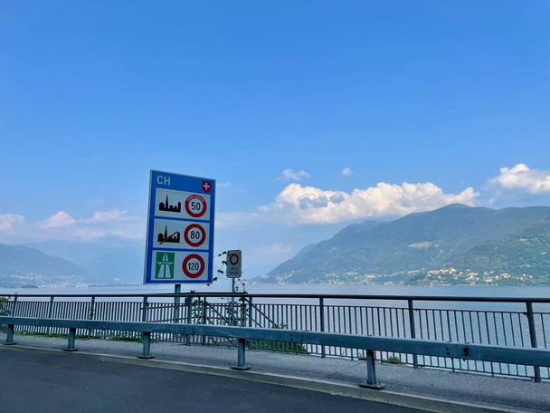 Country border sign at Swiss Italian border crossing Valmara Brissago at Lago Maggiore, Piedmont, Olaszország. Kiváló minőségű fénykép - Fotó, kép