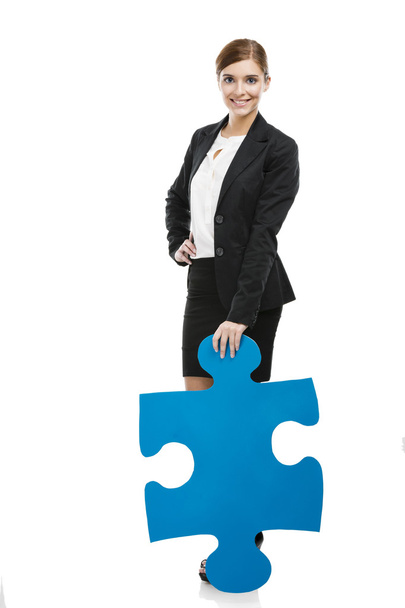 Businesswoman with a puzzle piece - Photo, Image