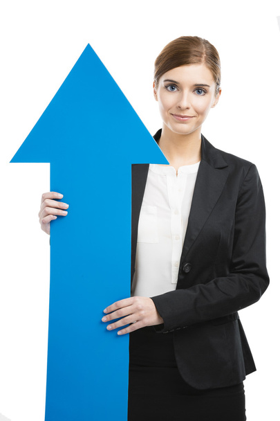 Business woman holding a blue arrow - Foto, imagen