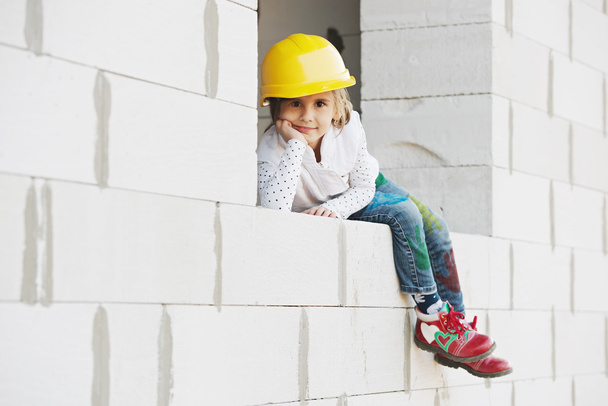 little girl with helmet working on construction - Фото, изображение