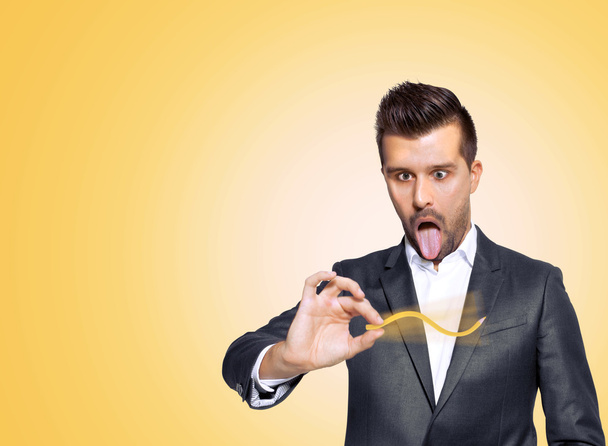 Stressed business man making crazy things with his yellow pencil - Photo, Image
