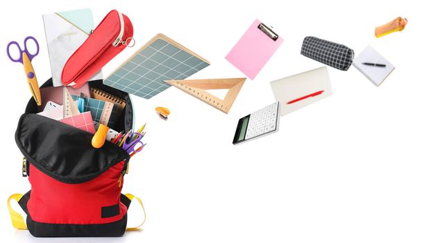 School backpack and different stationery on white background  - Photo, Image