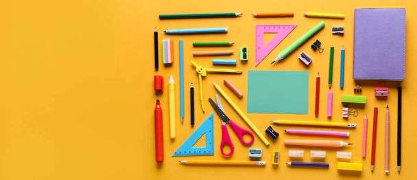 Different school supplies on orange background with space for text, top view - Fotó, kép