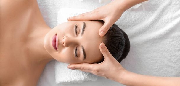 Beautiful young woman receiving massage in spa salon, top view - Fotó, kép