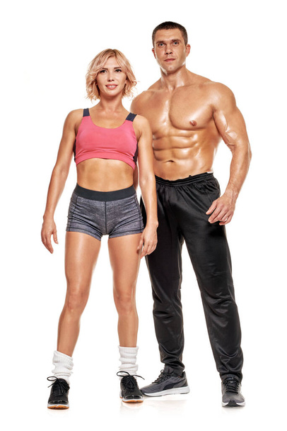 Happy couple in sportswear showing their muscular bodies - 写真・画像