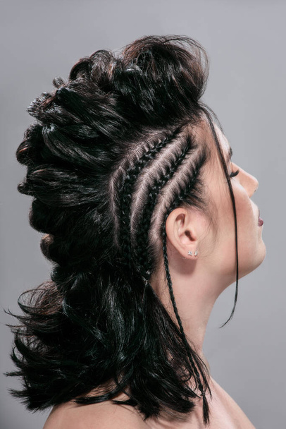 Brunette young woman with trendy creative braided hairstyle - Fotoğraf, Görsel