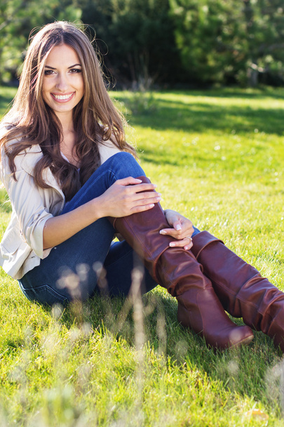 Young pretty teenager girl sitting on green grass - Valokuva, kuva