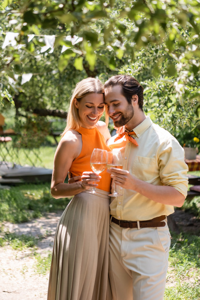 Stylish couple toasting wine in summer park  - Foto, immagini