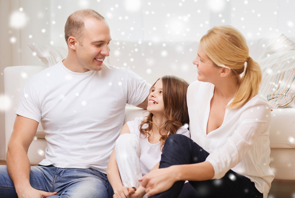 smiling parents and little girl at home - 写真・画像