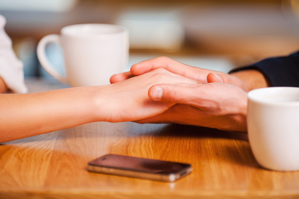 Couple holding hands  in cafe - Fotografie, Obrázek