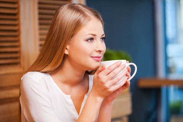 Woman enjoying coffee in cafe - Фото, изображение