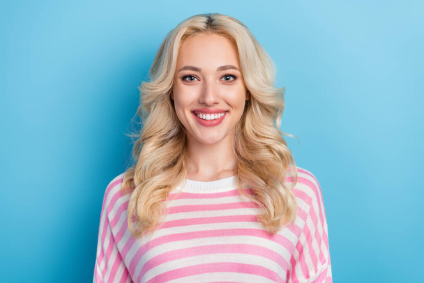 Photo of optimistic young blond hairdo lady wear pink shirt isolated on blue color background. - Foto, Bild