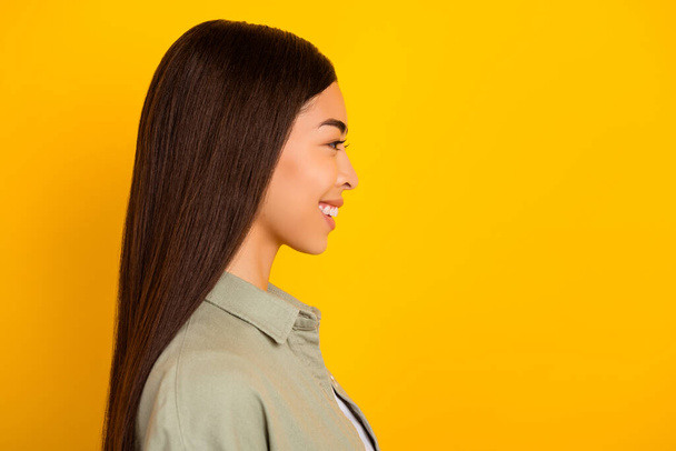 Profile side photo of adorable sweet young lady with long brunette hair look blank space isolated on yellow color background. - Φωτογραφία, εικόνα