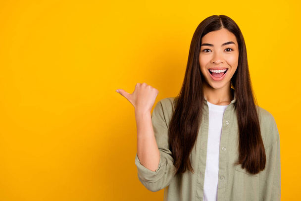 Photo of cheerful excited impressed girl promote recommend new job offer ad isolated on yellow color background. - Zdjęcie, obraz