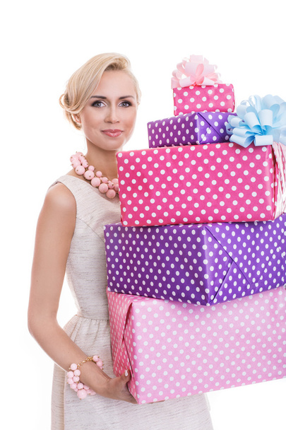 Beautiful blonde woman with a colorful gift boxes - Фото, изображение