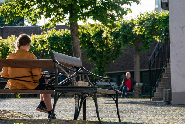 Stockholm, Sweden A woman sits on a bench in the in the Vallingby suburb. - Foto, immagini