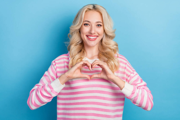 Photo of coquette millennial blond hairdo lady hand heart wear striped shirt isolated on blue color background. - Fotoğraf, Görsel