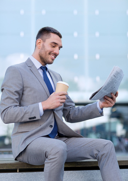 young businessman with coffee and newspaper - Foto, Bild