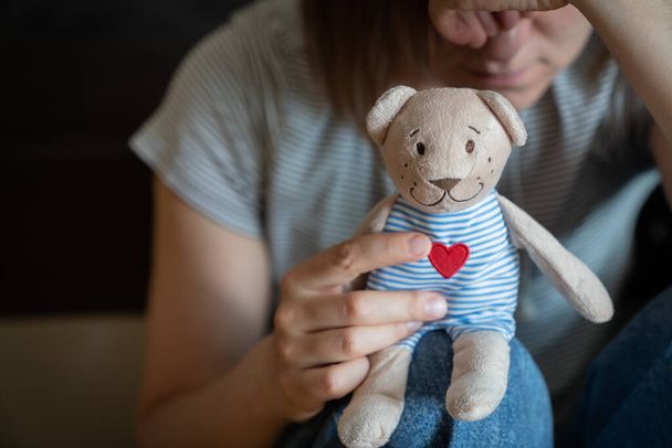 Perinatal loss reproductive chalenge concept - female holding a teddy bear toy. High quality photo - Foto, immagini