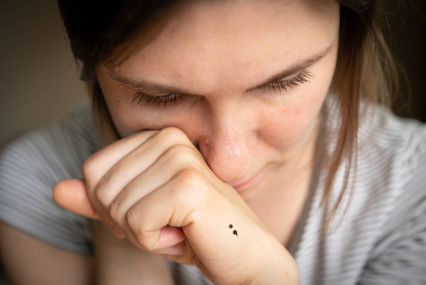 Depression concept - semicolon tattoo as symbol of mental illness. High quality photo - 写真・画像