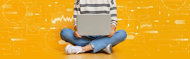 Gestutzte junge Europäerin sitzt auf dem Boden, tippt auf Laptop auf orangefarbenem Hintergrund mit abstrakten Symbolen, Collage, Panorama. Digitaler Nomade und Gadget, Freiberufler und modernes Arbeiten, Fernstudium - Foto, Bild