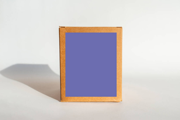 Closed brown cardboard box on a white background.purple,veri peri blank space for text. - Photo, Image