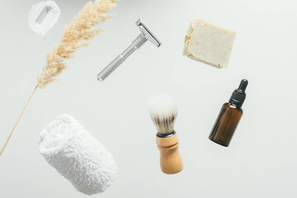 set for shaving with metal safe razor, wooden brush and soap. levitation concept flying objects - Zdjęcie, obraz