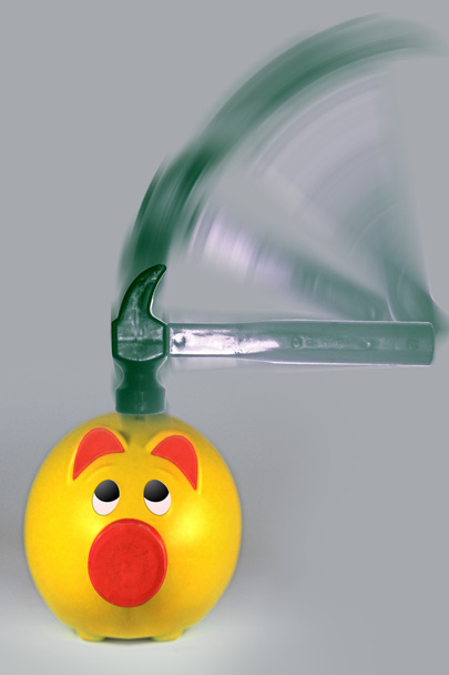 Hammer hitting a Piggy Bank, with motion blur - Photo, Image