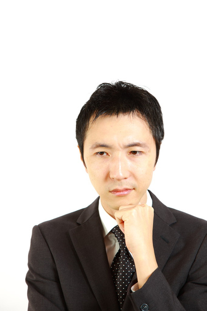 Japanese businessman thinks about something - Zdjęcie, obraz